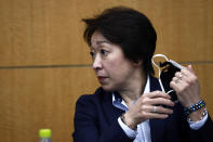 President of the Tokyo 2020 Olympics Organizing Committee Seiko Hashimoto removes her face mask as she attends the opening remark session of a press briefing on the operation and media coverage of Tokyo 2020 Olympic Torch Relay in Tokyo Thursday, Feb. 25, 2021. (Behrouz Mehri/Pool Photo via AP)
