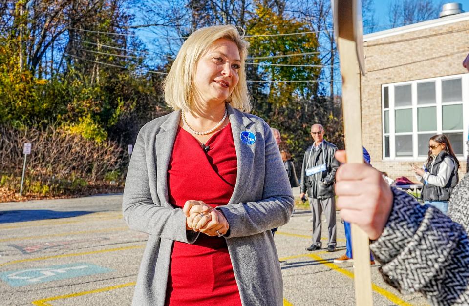 Ashley Kalus, the Republican nominee for governor, greets voters at the Johnston High School polling station last Nov. 8.
