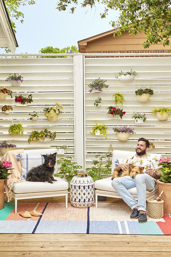 <p>Instead of splashing out on single-use party decor, use what you already have to spruce up walls and fences. Affix flat-backed planters to siding or fence panels, then fill them with a variety of flowers, herbs and bold greens. </p><p><a class="link " href="https://www.amazon.com/Hanging-Flowers-Planter-Container-Gardening/dp/B01D2FBXGY/?tag=syn-yahoo-20&ascsubtag=%5Bartid%7C10055.g.3620%5Bsrc%7Cyahoo-us" rel="nofollow noopener" target="_blank" data-ylk="slk:SHOP HANGING PLANTERS;elm:context_link;itc:0;sec:content-canvas">SHOP HANGING PLANTERS</a></p>