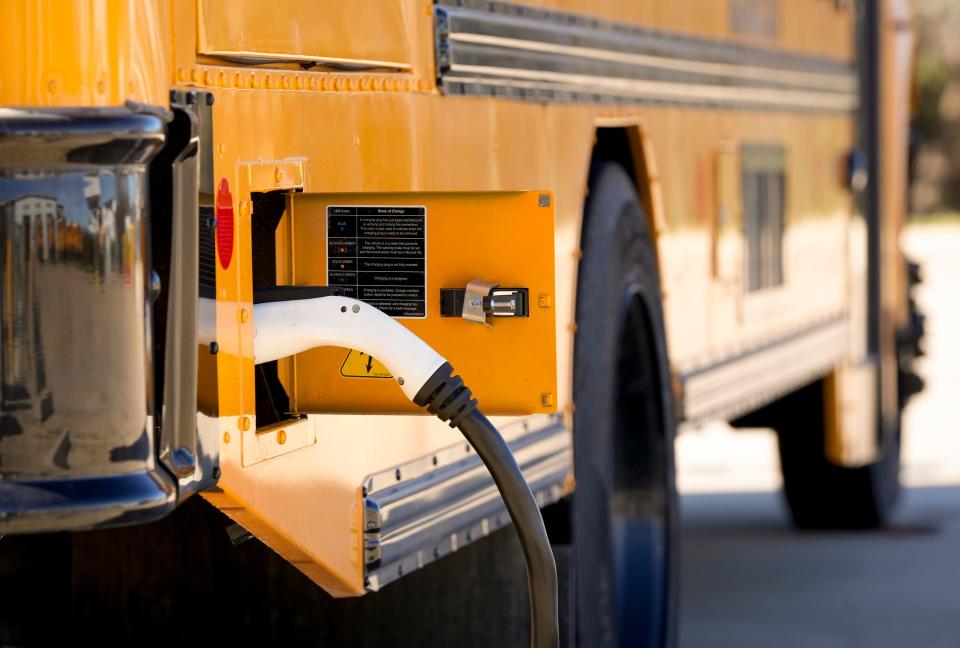 An electric school bus charges at the Austin Independent School District Southeast Bus Terminal on Monday January 29, 2024.