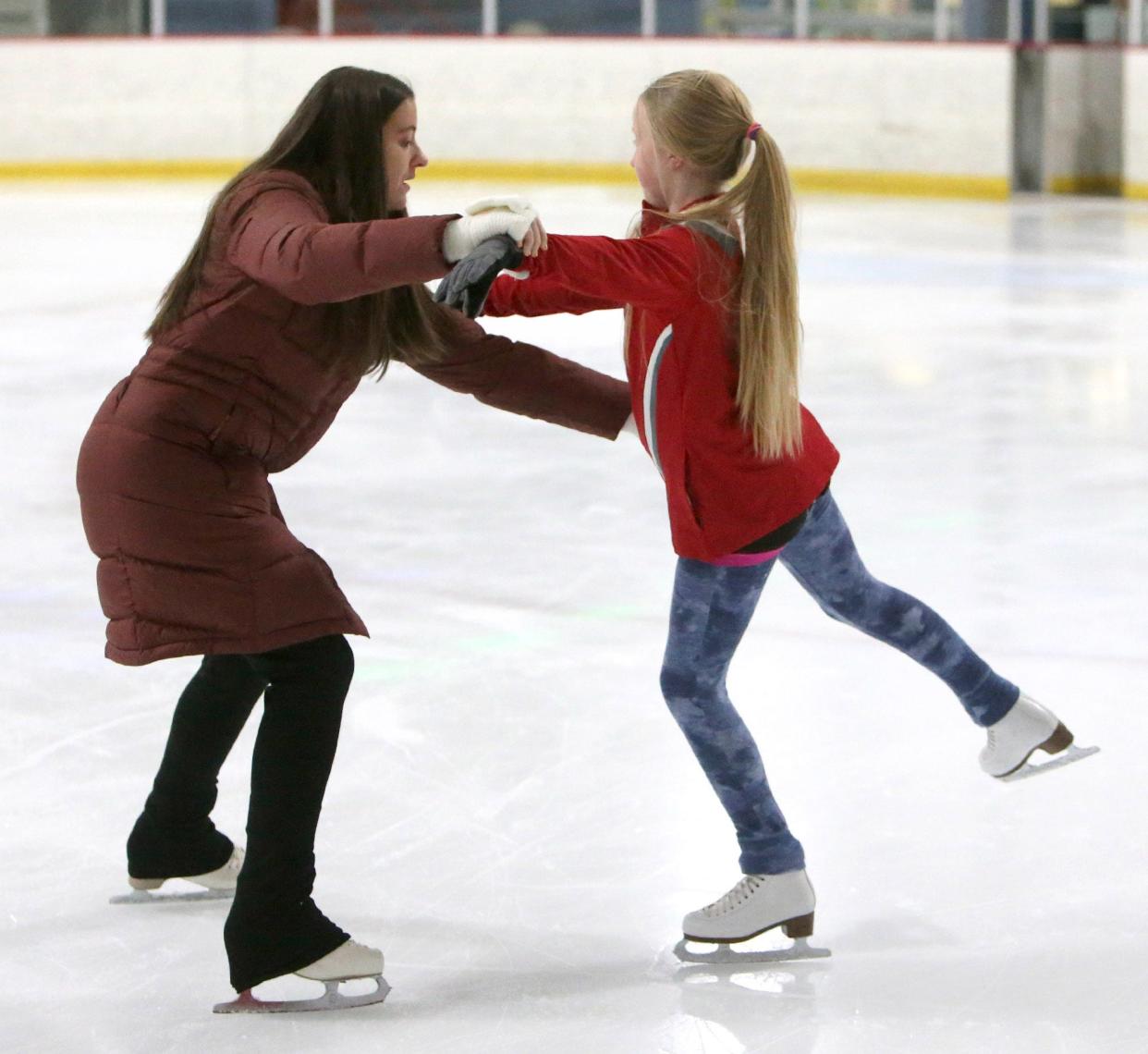 Skating coach Audrey Altieri, left, works with Ellie Krajeck, right, during figure skating lessons Friday, Jan. 14, 2022, at Center Ice Sports Complex in Jackson Township.