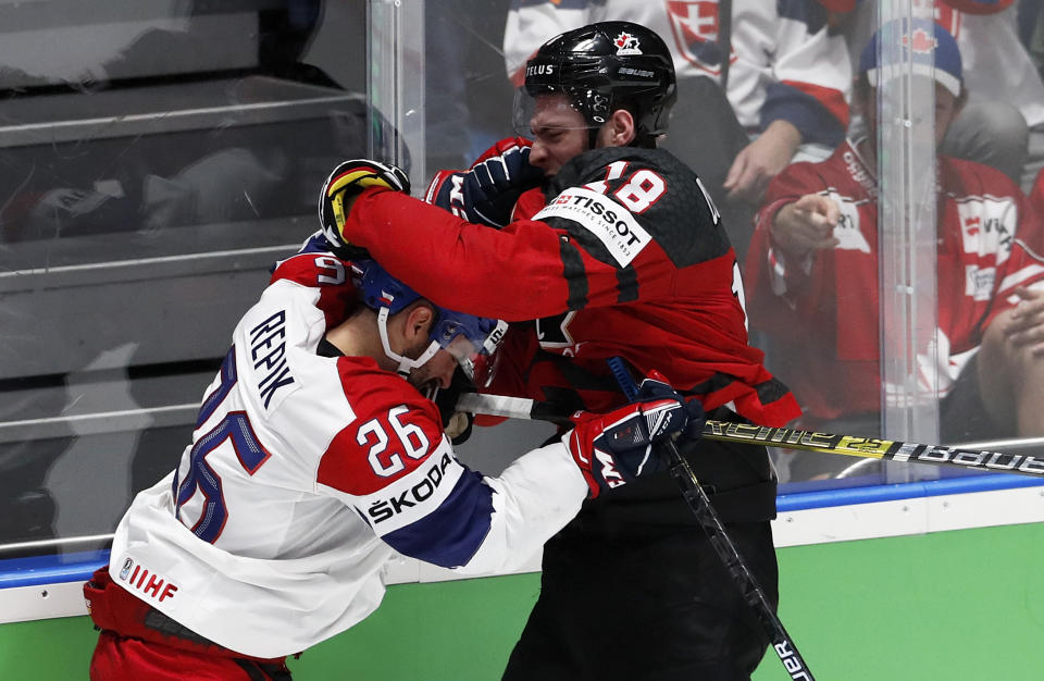 Czech Republic's Michal Repik, left, and Canada's Pierre-Luc Dubois get involved in a scuffle during the Ice Hockey World Championships semifinal match between Canada and Czech Republic at the Ondrej Nepela Arena in Bratislava, Slovakia, Saturday, May 25, 2019. (AP Photo/Petr David Josek)