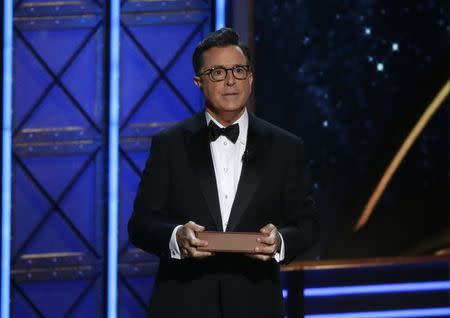 69th Primetime Emmy Awards – Show – Los Angeles, California, U.S., 17/09/2017 - Host Stephen Colbert holds a book as he speaks during the show. REUTERS/Mario Anzuoni