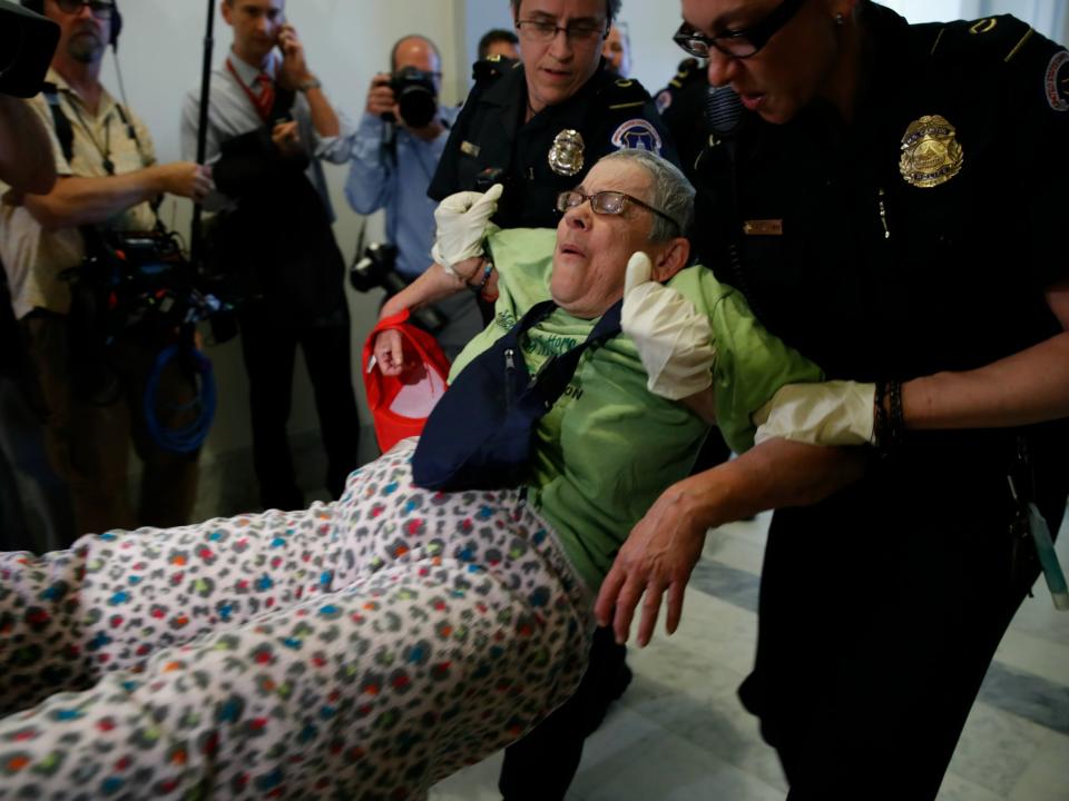 In some instances, police helped protesters back into their wheelchairs before forcibly removing them, but others weren't treated so generously: Jacquelyn Martin/AP