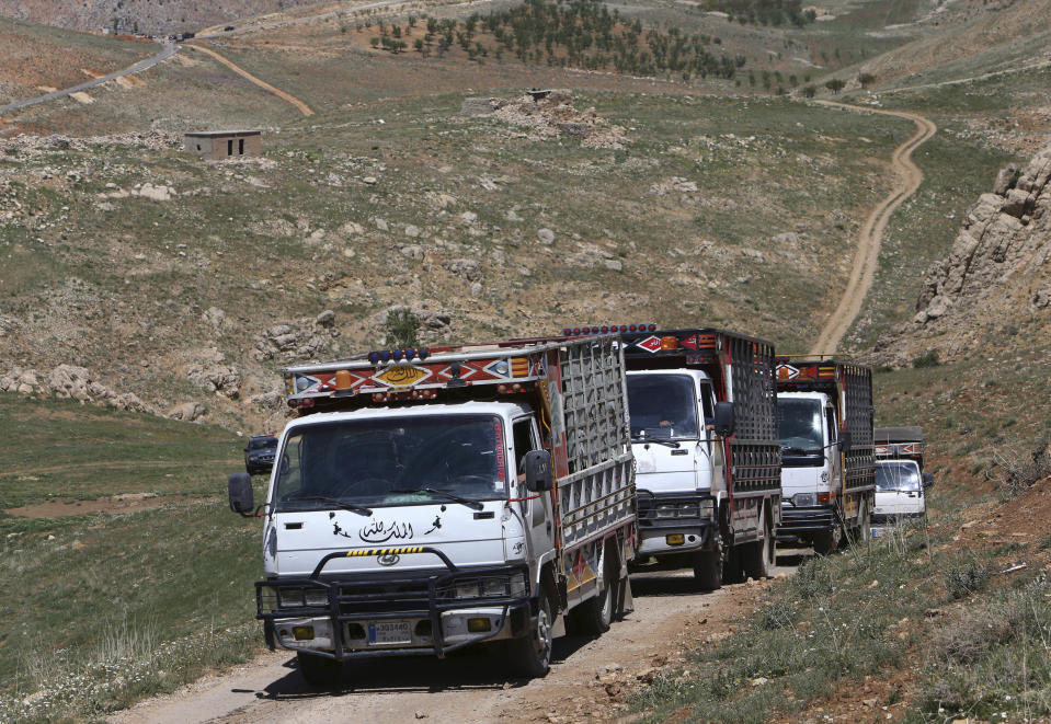 Small trucks carrying aid supplies drive to Tfail village, in Ras al-Haref at the Lebanese-Syrian border, eastern Lebanon, Tuesday April 22, 2014. A Lebanese convoy of soldiers, clerics and Red Cross officials delivered aid Tuesday to a remote village near the Syrian border that was bombed by Syrian government aircraft and blocked by Lebanese militants fighting alongside President Bashar Assad’s forces in the civil war next door. Hezbollah fighters have been patrolling the area on the Lebanese side and fighting has flared up inside Syria, cutting Tfail’s residents off from all sides for months. (AP Photo/Hussein Malla)