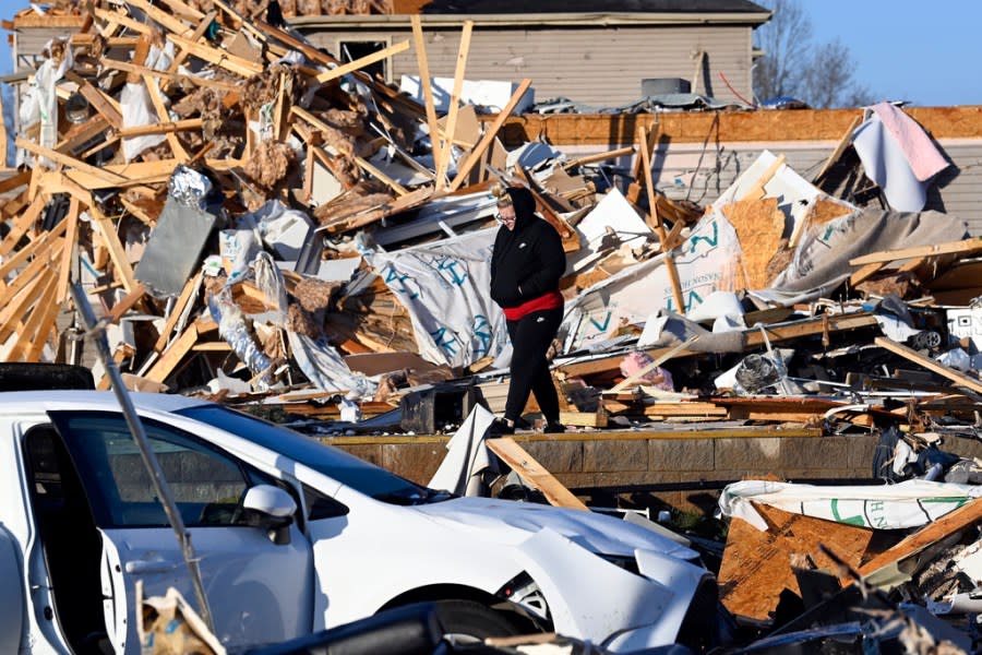 Amber Gardner looks at the debris from a friend’s destroyed house in the West Creek Farms neighborhood on Sunday, Dec. 10, 2023, Clarksville, Tenn. Central Tennessee residents and emergency workers are continuing the cleanup from severe weekend storms. (AP Photo/Mark Zaleski)