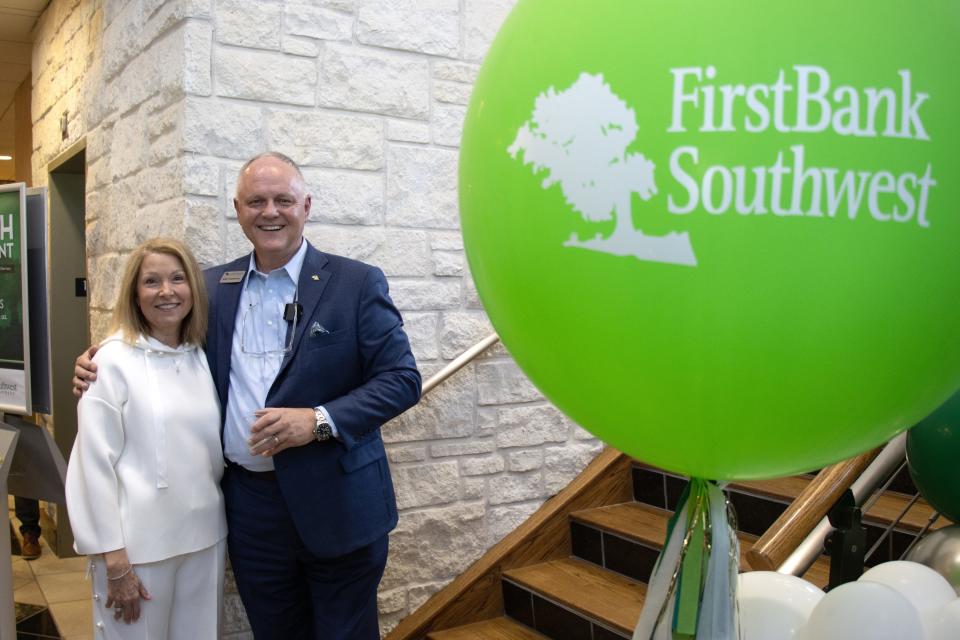 Andy Marshall, President and CEO, and his wife Denise Marshall get a photo taken at the FirstBank Southwest 115th anniversary celebration Tuesday on Georgia Street.