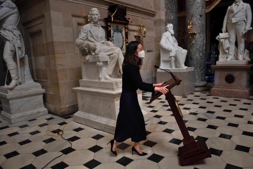 A staff member moves Speaker of the House Nancy Pelosi's lectern which was stolen as a pro-Trump mob took over the Capitol building last week January 13, 2021, in Washington, DC.