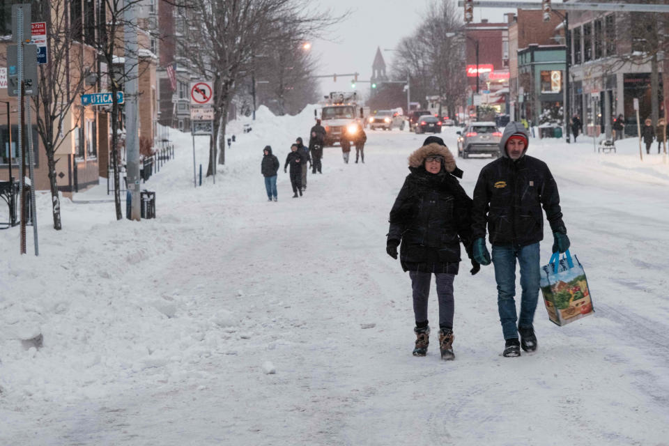 People walk along a snow-covered street in Buffalo, N.Y. (Joed Viera / AFP - Getty Images)