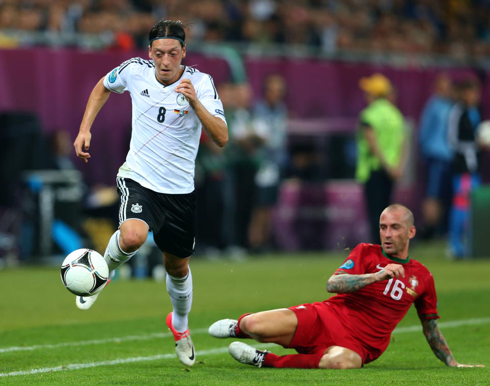 L'VIV, UKRAINE - JUNE 09: Mesut Ozil of Germany breaks past Raul Meireles of Portugal during the UEFA EURO 2012 group B match between Germany and Portugal at Arena Lviv on June 9, 2012 in L'viv, Ukraine. (Photo by Alex Livesey/Getty Images)