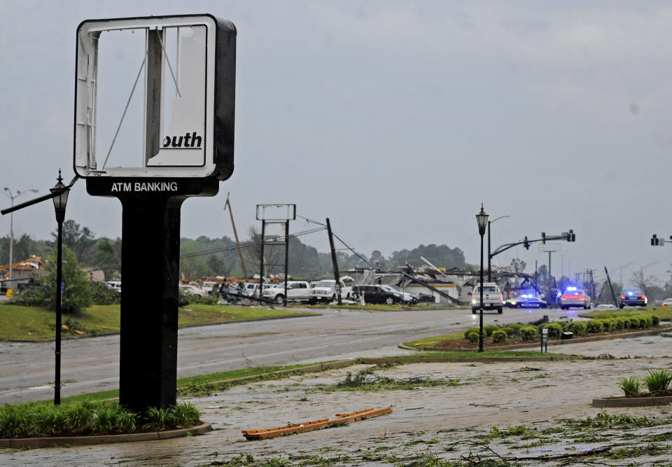 Buildings are damaged along Gloucester Street after a tornado in Tupelo, Miss., Monday, April 28, 2014. Tornados flattened homes and businesses, flipped trucks over on highways and injured numerous people in Mississippi and Alabama on Monday as a massive, dangerous storm system passed over several states in the South, threatening additional twisters as well as severe thunderstorms, damaging hail and flash floods. (AP Photo/The Daily Mississippian, Thomas Graning)
