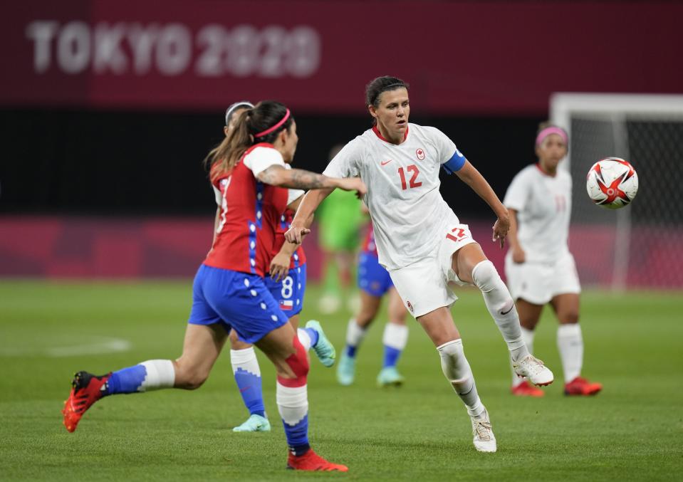 Chile's Carla Guerrero, left, and Canada's Christine Sinclair fight for the ball during a women's soccer match at the 2020 Summer Olympics, Saturday, July 24, 2021, in Sapporo, Japan. (AP Photo/Silvia Izquierdo)