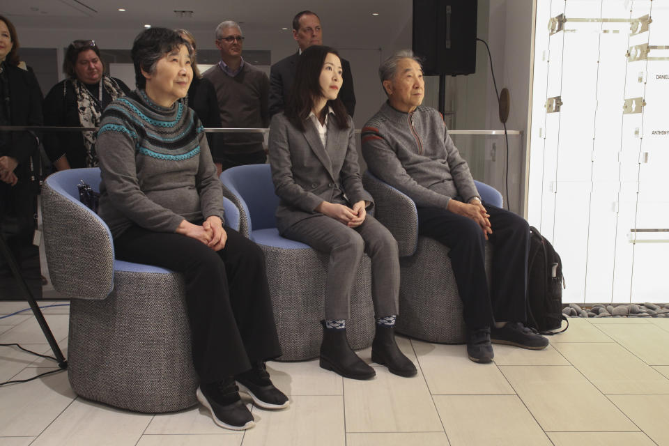 Rao Jiping, left, and her brother Rao Jian, far right, listen with their translator Caroline Chen during a ceremony at the Associated Press headquarters in New York, Wednesday, Dec. 11, 2019, honoring their father Y.C. Jao for his service as a Chinese correspondent working for the AP in China at the time of the Communist Red Army's victory over Nationalist forces and its conquest of China. Jao continued to work for AP in Nanjing even after American correspondents were evicted from the country. His passion for journalism led to his execution in 1951. (AP Photo/ Chuck Zoeller)