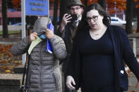 The mother of Patrick Dai, left, leaves the U.S. District Court with her son's attorney in Syracuse, N.Y., Wednesday, Nov. 1, 2023. Dai, a 21-year-old Cornell University student accused of posting threats online to shoot and stab Jewish people on the campus, waived his right to a bail hearing during his first appearance in federal court Wednesday. The judge ordered him to remain in Broome County jail, where he has been since he was arrested. (AP Photo/Adrian Kraus)