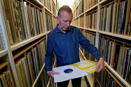 Andy Linehan, Curator of Popular Music Recordings at the British Library, checks a limited edition pressing of Mendelssohn's Violin Concerto in E Minor 1948 recording - the very first 33rpm vinyl LP to be issued - before it is added into the British Library's musical collection of over 250 000 pieces, in London, Britain, June 15, 2018. REUTERS/Toby Melville