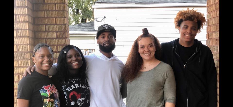 Mario Daugherty and Ashlea Burr, center, with their three children.