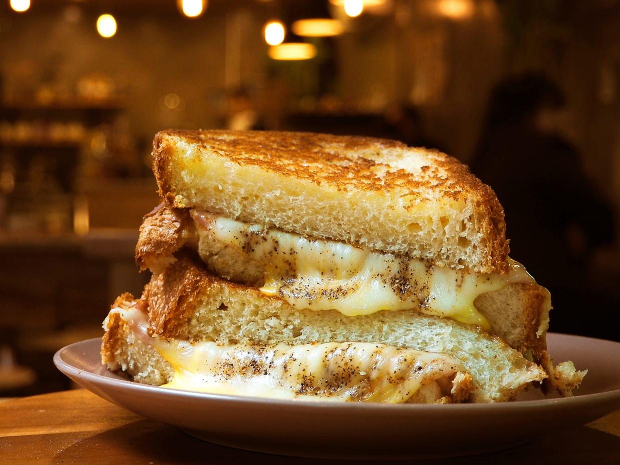 A stacked grill cheese sandwich on a plate.