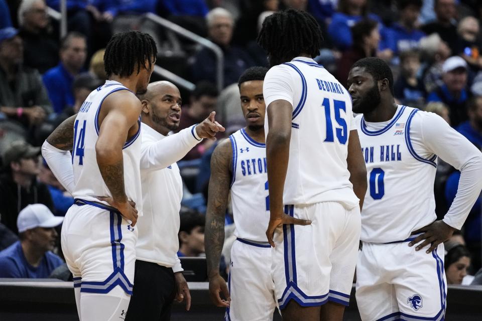 Seton Hall head coach Shaheen Holloway talks to Dre Davis (14), Jaden Bediako (15), Dylan Addae-Wusu (0) and Al-Amir Dawes (2) during the first half of an NCAA college basketball game against Marquette Saturday, Jan. 6, 2024, in Newark, N.J. (AP Photo/Frank Franklin II)