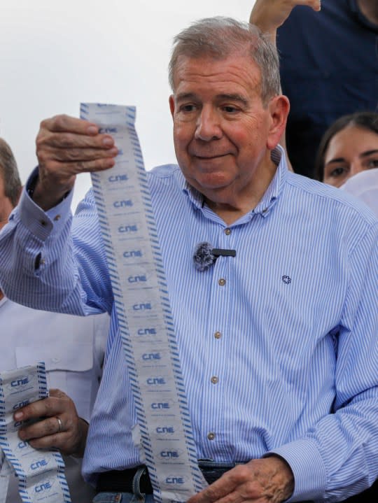 Opposition candidate Edmundo Gonzalez holds up vote tally sheets from the top of a truck during a protest against the official presidential election results declaring President Nicolas Maduro the winner in Caracas, Venezuela, on Tuesday, July 30, 2024, two days after the election. (AP Photo/Cristian Hernandez)