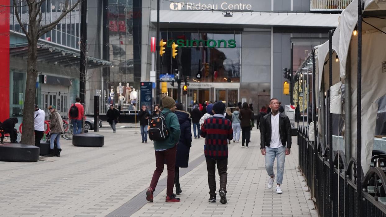 Ottawans walk near the Rideau Centre on April 9, 2022. The Ottawa Police Services board has approved a plan to set up a new 'neighbourhood operations centre' in the mall. (Joseph Tunney/CBC - image credit)