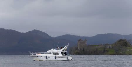 A boat sails in front of Urquhart Castle on Loch Ness in Scotland, Britain April 13, 2016. REUTERS/Russell Cheyne