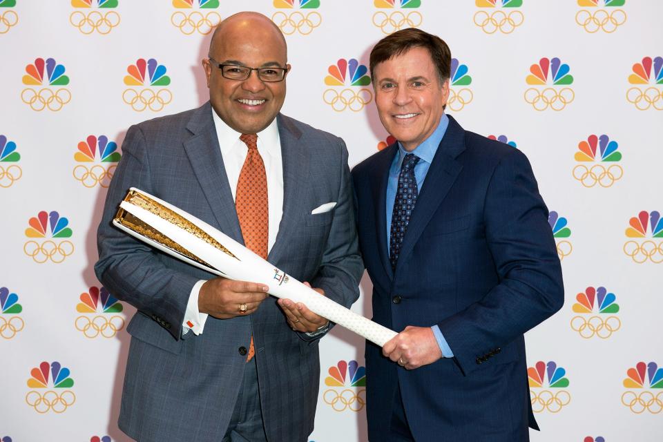 Bob Costas (right), who has served as NBC?s primetime host for a U.S. record 11 Olympics, passes the Olympic torch to Mike Tirico (left), who will make his debut as NBC?s primetime Olympic host at The Winter Olympics in PyeongChang, South Korea, in 2018 --