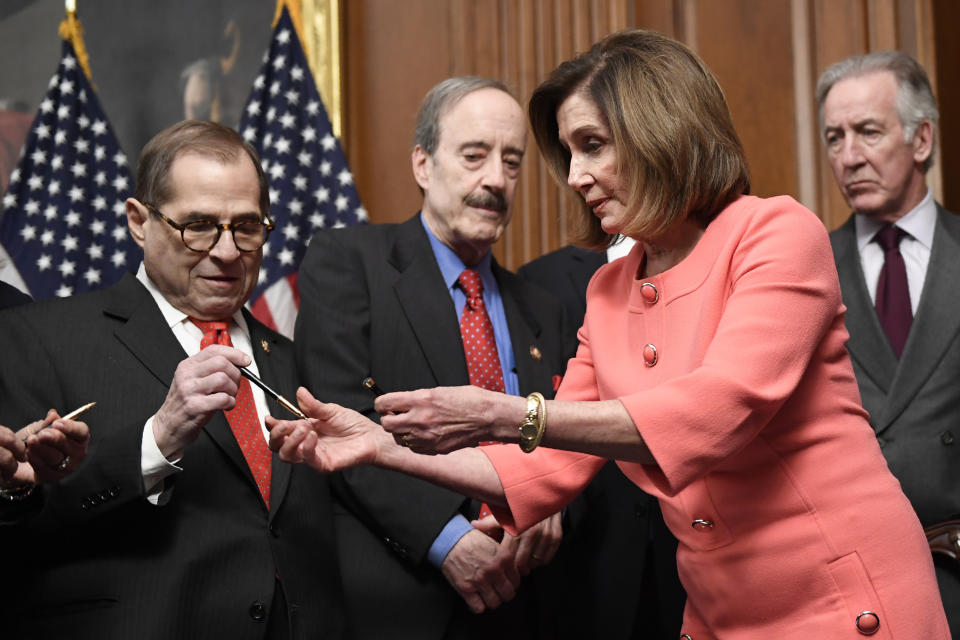 House Speaker Nancy Pelosi of Calif., second from right, gives pens to, from left, House Judiciary Committee Chairman Rep. Jerrold Nadler, D-N.Y., House Foreign Affairs Committee Chairman Rep. Eliot Engel, D-N.Y., and House Ways and Means Committee Chairman Rep. Richard Neal, D-Mass., after she signed the resolution to transmit the two articles of impeachment against President Donald Trump to the Senate for trial on Capitol Hill in Washington, Wednesday, Jan. 15, 2020. The two articles of impeachment against Trump are for abuse of power and obstruction of Congress. (AP Photo/Susan Walsh)