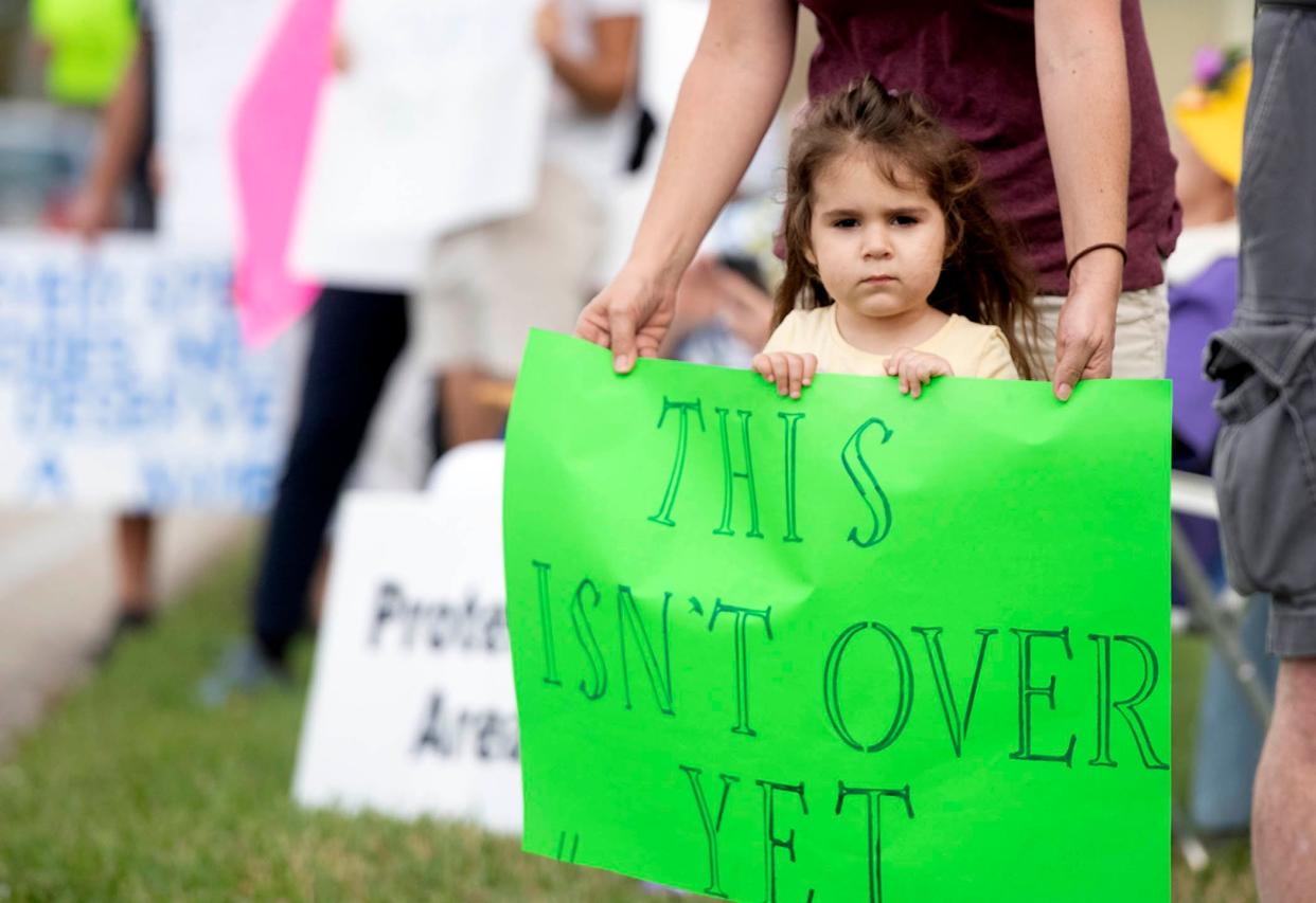 Bryn Lippo, 3, demonstrates with her mother Laura, both of North Palm Beach, during the "Bigger Than Roe" rally Sunday along Palm Beach Lakes Boulevard. The rally was sponsored by the Democratic Women’s Club of Palm Beach County and the Palm Beach County National Organization for Women.