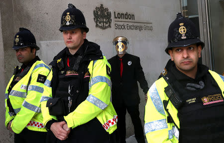 Police stands guard as demonstrators glue their hands to the London stock exchange during the Extinction Rebellion protest in London, Britain April 25, 2019. REUTERS/Simon Dawson