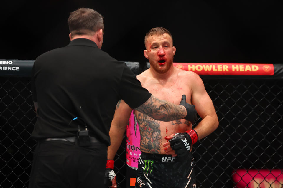 Apr 13, 2024; Las Vegas, Nevada, USA; Justin Gaethje (red gloves) is helped to the corner of the cage while fighting Max Holloway (not pictured) during UFC 300 at T-Mobile Arena. Mandatory Credit: Mark J. Rebilas-USA TODAY Sports