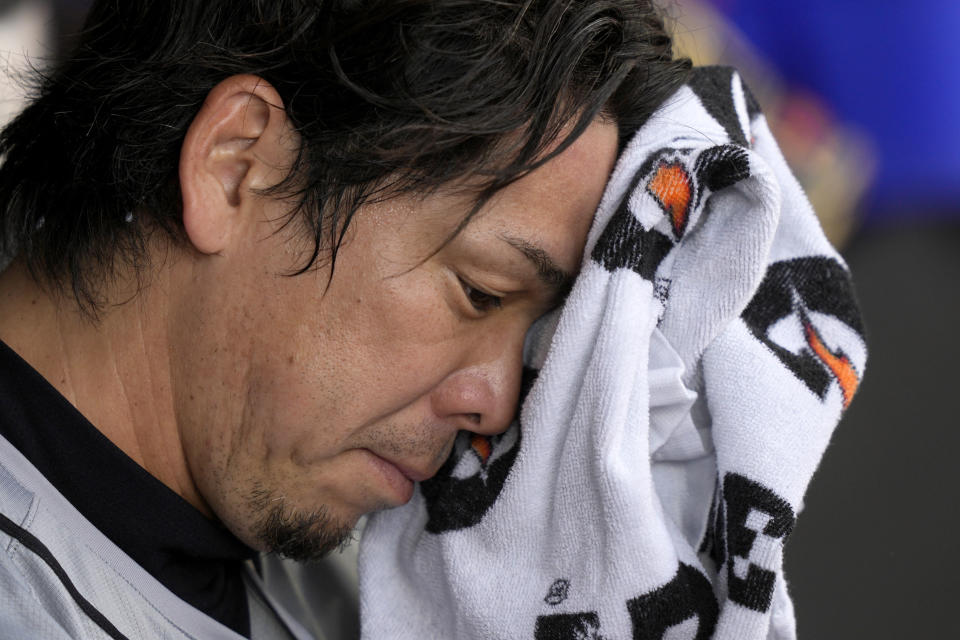 Detroit Tigers starting pitcher Kenta Maeda wipes his face in the dugout after pitching in the third inning of a baseball game against the Chicago White Sox Saturday, March 30, 2024, in Chicago. (AP Photo/Charles Rex Arbogast)