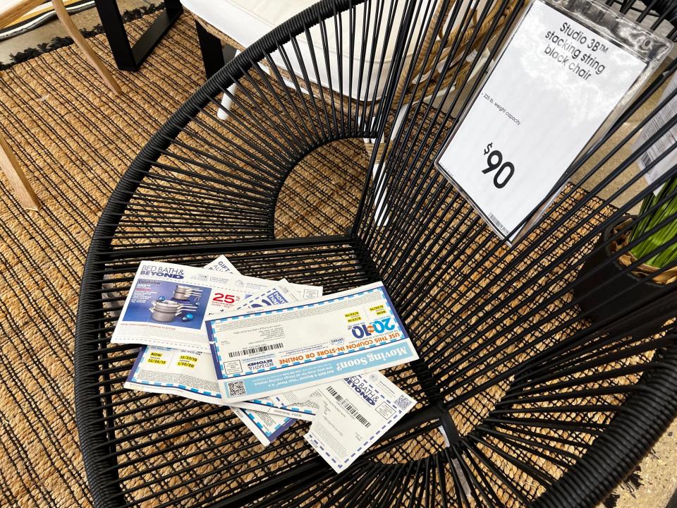 A stack of coupons on a chair at a Bed Bath & Beyond store