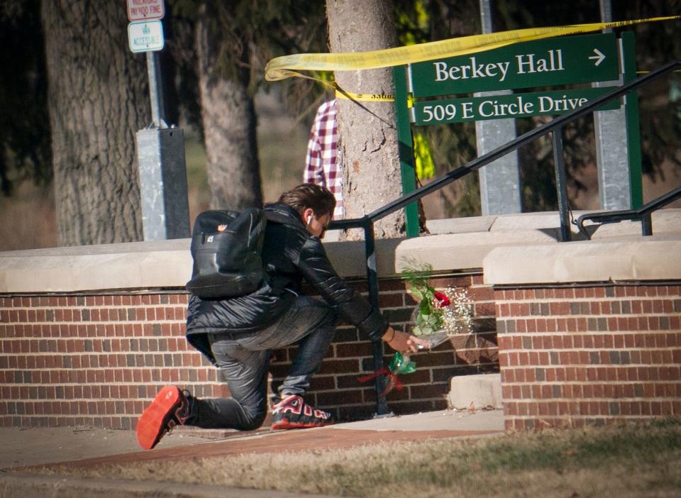 Flowers are placed on the steps behind Berkey Hall on the campus of MSU on Feb. 14, 2023.