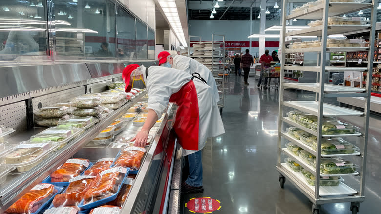 Costco deli workers stocking case