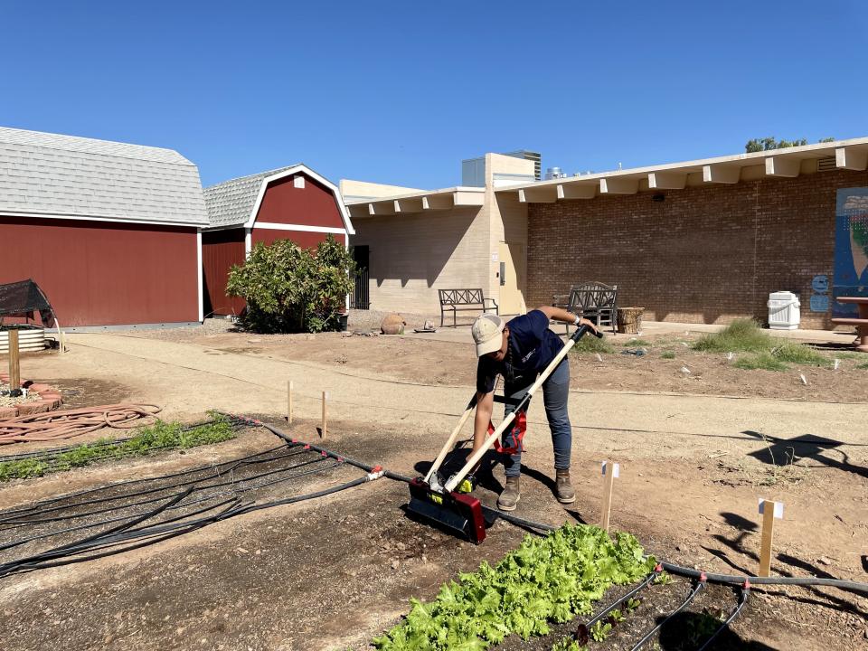 Sara Hipperson demonstrates the use of tilling tools for small-scale operations at the Maricopa County Cooperative Extension during the opening of the People's Demonstration Farm on Oct. 18, 2023.