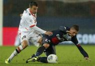 Paris St Germain's Marco Verratti (R) challenges FC Lorient's Yann Jouffre during their French Ligue 1 soccer match at the Parc des Princes Stadium in Paris November 1, 2013. REUTERS/Benoit Tessier