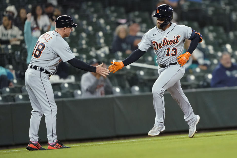 Detroit Tigers' Eric Haase (13) is greeted by third base coach Chip Hale after Haase hit a solo home run during the second inning of a baseball game against the Seattle Mariners, Monday, May 17, 2021, in Seattle. (AP Photo/Ted S. Warren)