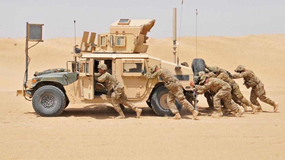 Soldiers from 1st Battalion, 66th Armor Regiment push a Humvee on April 9, 2015 in Kuwait. This was the Iron Knights' first of five deployments in a 10 year span. (Spc. Gregory T. Summers/Army)