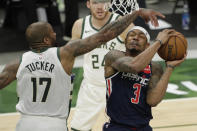 Washington Wizards' Bradley Beal (3) is fouled by Milwaukee Bucks' P.J. Tucker (17) during the first half of an NBA basketball game Wednesday, May 5, 2021, in Milwaukee. (AP Photo/Aaron Gash)