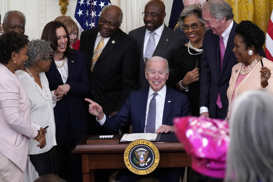 FILE - In this Thursday, June 17, 2021 file photo, President Joe Biden points to Opal Lee after signing the Juneteenth National Independence Day Act, in the East Room of the White House in Washington. From left are, Rep. Barbara Lee, D-Calif, Rep. Danny Davis, D-Ill., Opal Lee, Sen. Tina Smith, D-Minn., Vice President Kamala Harris, House Majority Whip James Clyburn of S.C., Sen. Raphael Warnock, D-Ga., Sen. John Cornyn, R-Texas, obscured, Rep. Joyce Beatty, D-Ohio, Sen. Ed Markey, D-Mass., and Rep. Sheila Jackson Lee, D-Texas. With the recent passage of the act, commemorating the end of slavery in the United States, the country now has 12 federal holidays. (AP Photo/Evan Vucci)