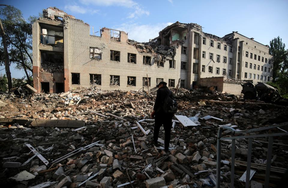 A man walks amid the rubble of Zaytseve (EPA)