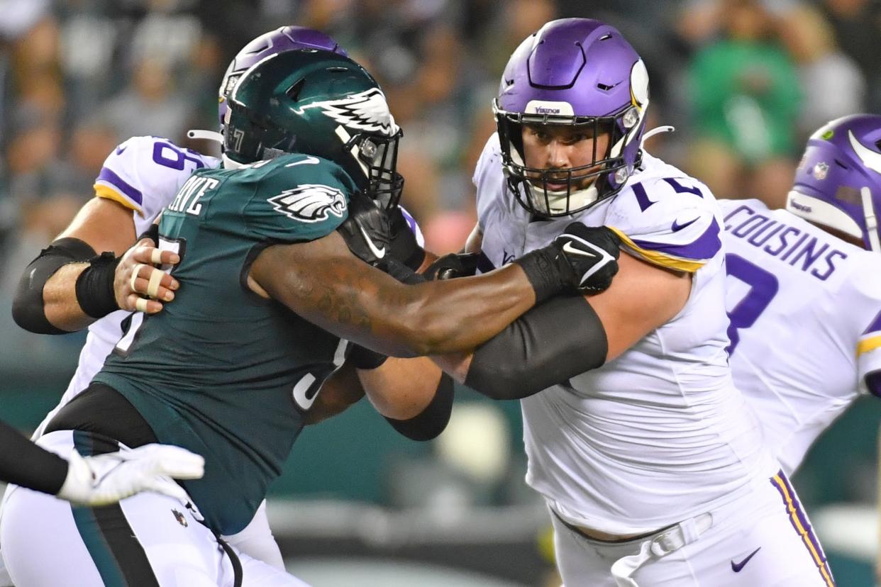 Minnesota Vikings guard Ezra Cleveland blocks Philadelphia Eagles defensive tackle Javon Hargrave.