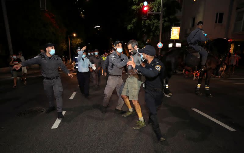 Israelis protest against law that limits protests during the coronavirus disease (COVID-19) lockdown, in Tel Aviv