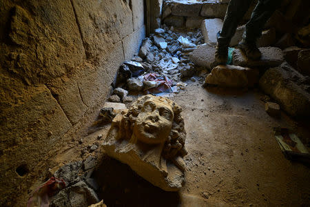 A destroyed artifact is seen at the ancient city of Hatra, south of Mosul, Iraq April 27, 2017. REUTERS/Stringer