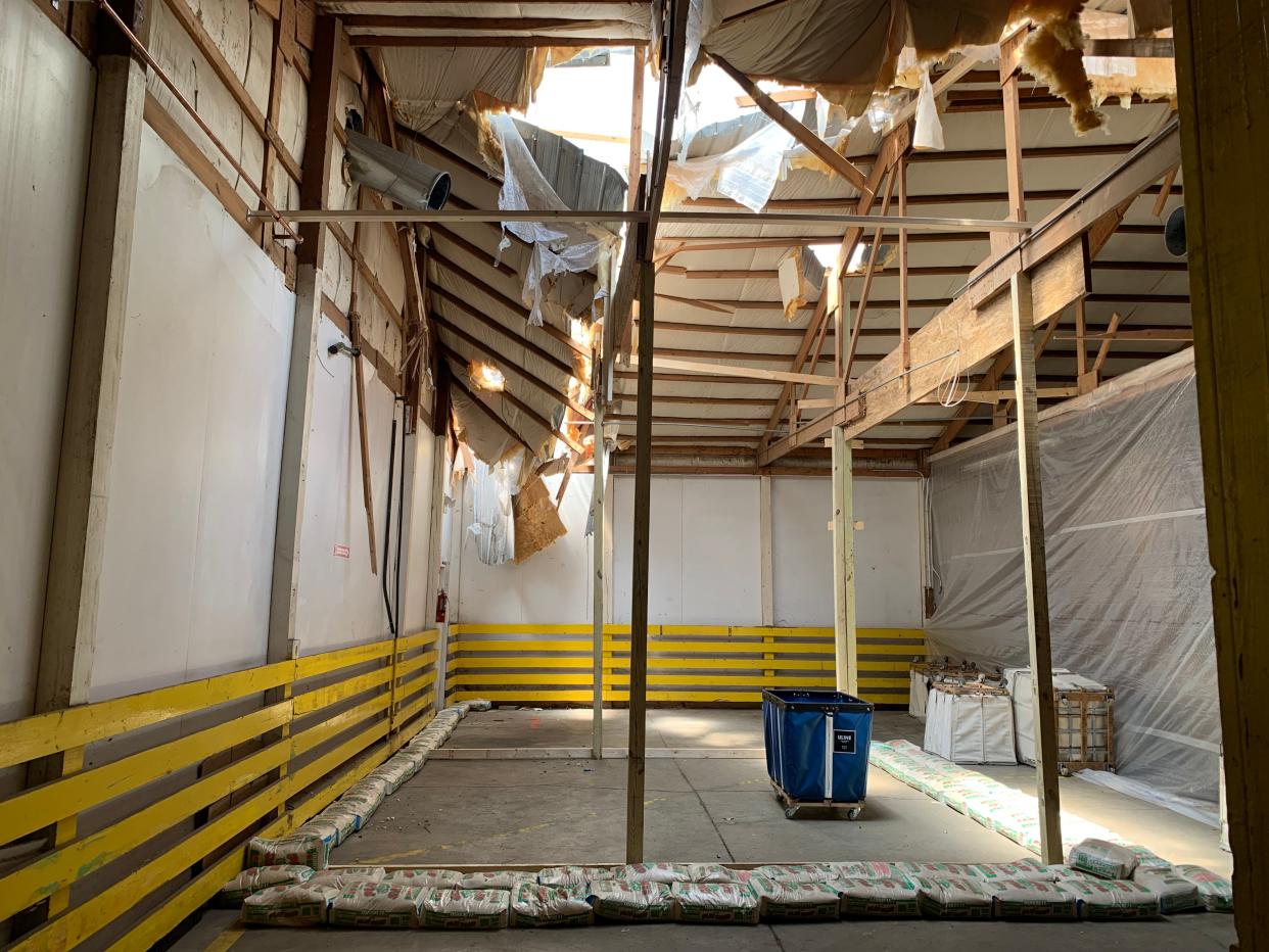 A hole still gapes in the ceiling of a warehouse owned by Goodwill Wayne and Holmes counties. The site stored many boxes of donated goods that were destroyed in a flood caused by a tree falling through the roof during a storm.