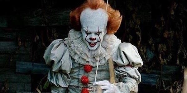 Pennywise holding a balloon looking evil