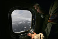 <p>Lyn Lohberger of NASA looks out as sea ice floats near the coast of West Antarctica from a window of a NASA Operation IceBridge airplane on October 27, 2016 in-flight over Antarctica. (Photo: Mario Tama/Getty Images) </p>