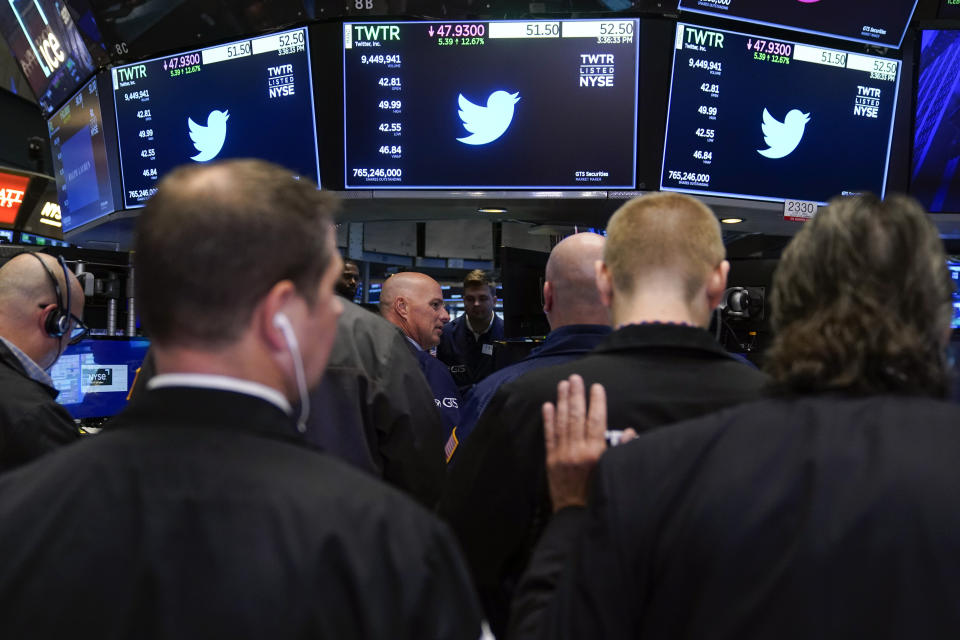 Traders gather around a post as Twitter shares resume trading on the floor at the New York Stock Exchange in New York, Tuesday, Oct. 4, 2022. (AP Photo/Seth Wenig)