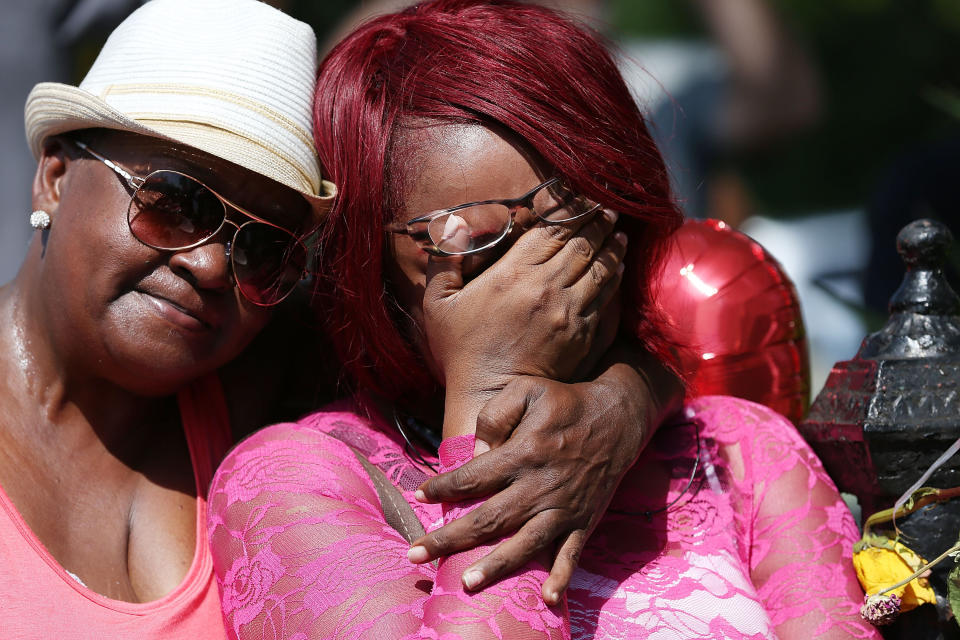 CHARLESTON, SC - JUNE 21:  People stand together in front of the Emanuel African Methodist Episcopal Church as they listen to a broadcast of the Sunday service taking place after a mass shooting at the church killed nine people on June 21, 2015 in Charleston, South Carolina. Dylann Roof, 21 years old, is suspected of killing the nine people during a prayer meeting in the church, which is one of the nation's oldest black churches in Charleston.  (Photo by Joe Raedle/Getty Images)