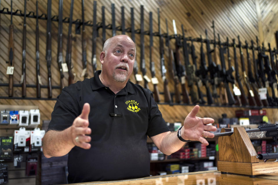 FILE - Rick LaChapelle, owner of Coastal Trading and Pawn, is seen at the counter of his gun shop in Auburn, Maine, in this July 18, 2022, file photo. LaChapelle's staff declined to release a gun suppressor in August to Robert Card, the man authorities have identified as the gunman in the shooting that left 18 dead in Lewiston. (AP Photo/Robert F. Bukaty, files)